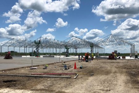 a shot of a greenhouse being built and is under construction