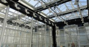 a shot of a Dual Interior Shade Energy Curtain installed in a Bayer Cropscience greenhouse by Prospiant