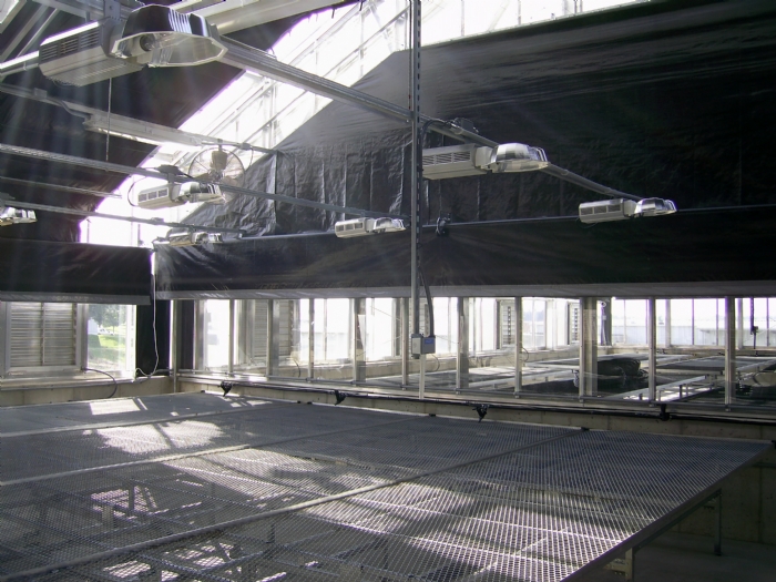 Internal greenhouse shading with energy curtains used for crop day length adjustment and effective heat retention at night