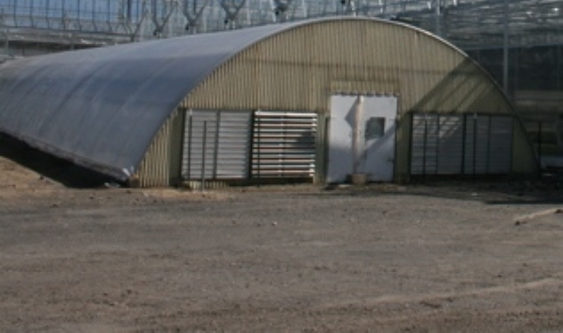 a view from the outside of a Ground-to-Ground Greenhouses