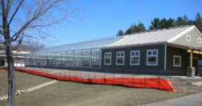 a shot of a Steel Utility Building with wooden building attached to it.