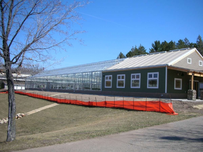 a shot of a Steel Utility Building with wooden building attached to it.