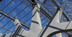 A shot of the glass sky atrium from below with the focus on the pillar