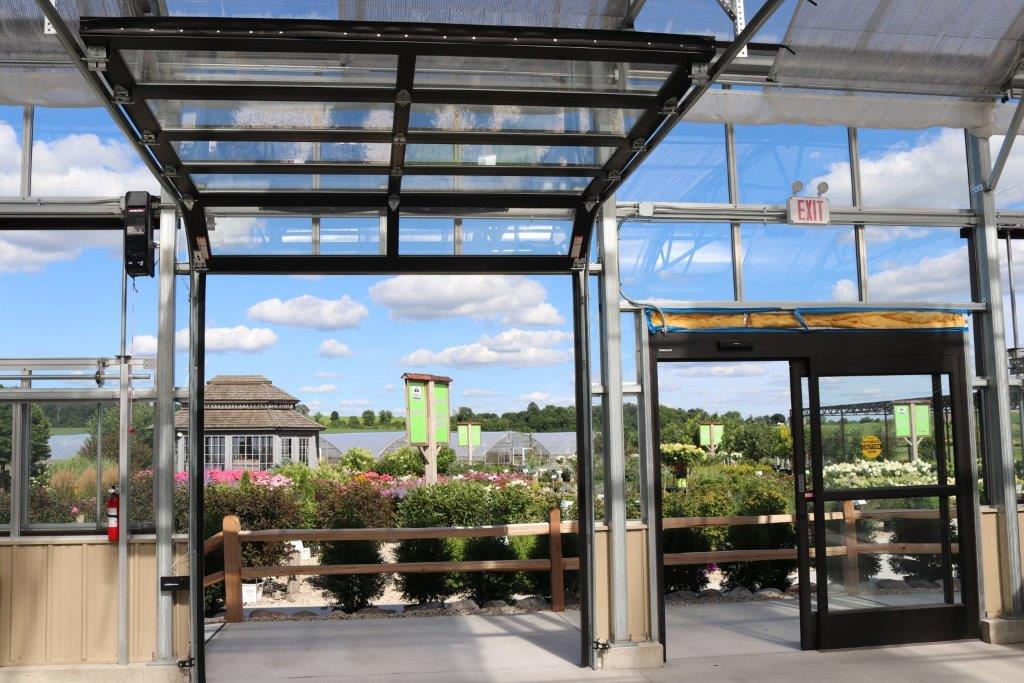 a shot from the inside of a Heavy Duty Greenhouse by Prospiant with sliding doors
