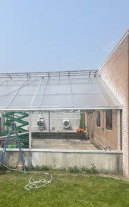 New glazing and greenhouse climate control installation on older MSU greenhouse