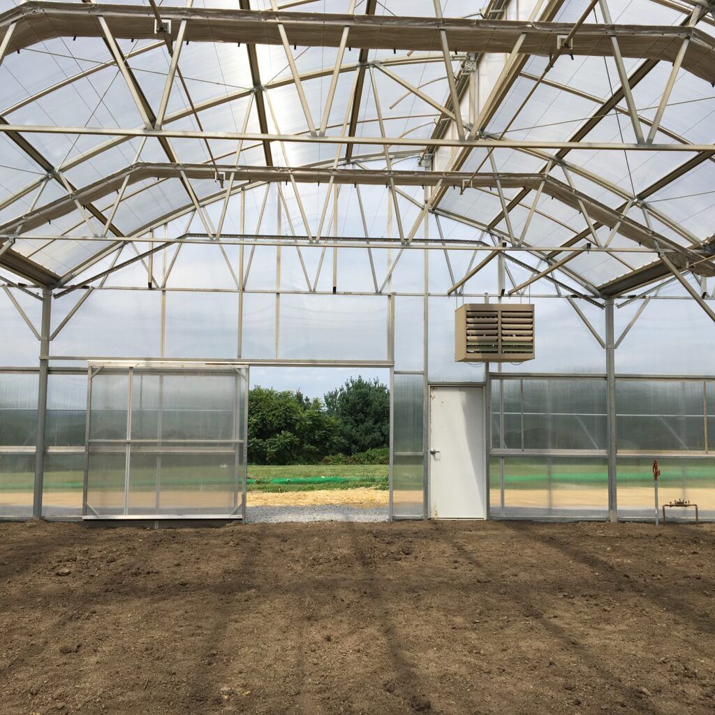 Zephyr greenhouse with sliding door in endwall at Plant Marketing, WI