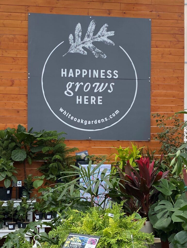 Sign that shows the theme at White Oak Gardens -- Happiness Grows Here