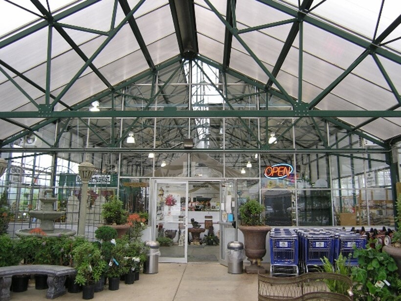 Green colored greenhouse trusses with powder-coating add to the atmosphere at a retail greenhouse