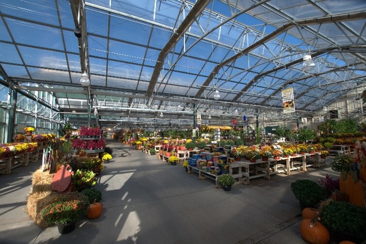 Curved bottom chord trusses make the greenhouse space feel taller, lighter, and more spacious